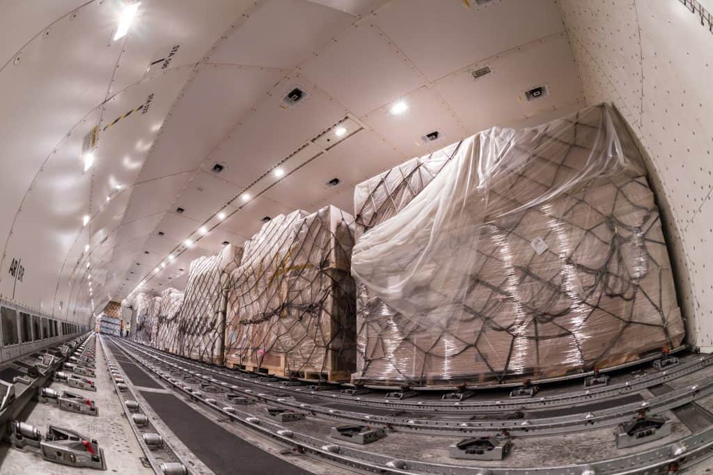 Cargo pallets being loaded into cargo plane.