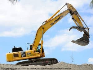 Excavator moving dirt for oversized shipment.