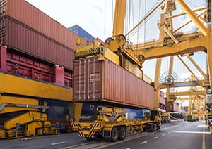 Cargo container being lifted from a container truck.